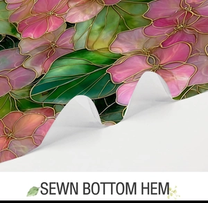 Detail view of the sewn bottom hem on a floral stained glass style fabric shower curtain