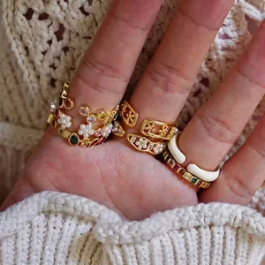 Rainbow gemstone rings with small pearls and floral design on a gold open band