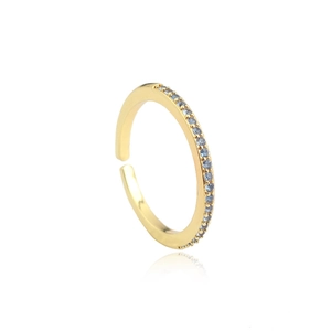 Detail of gold open ring with micro-set blue zircons and polished finish on white background