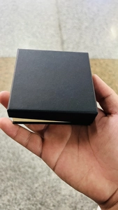 Close-up of black square jewelry gift box with elegant gold inner lining detail