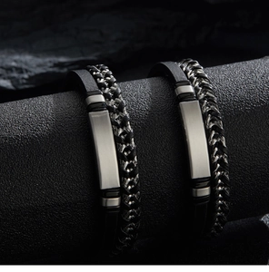 Close-up of black braided leather men's bracelet with silver metal plate and magnetic clasp