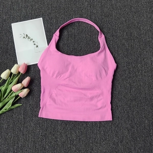 Detailed flat lay of a pink ribbed halter sports top with high-stretch knit fabric texture
