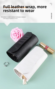 Detail of waterproof PU leather jewelry roll organizer with elegant tassel and cross texture