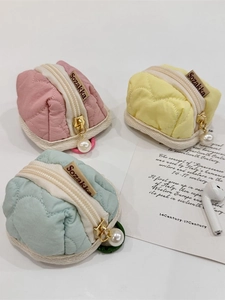 Quilted heart headphone pouches in pink, yellow, and mint green with pearl zipper charms