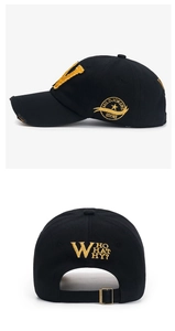 Detail of vintage black baseball cap with distressed brim and yellow letter V embroidery