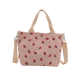 Pink corduroy tote bag with red strawberry pattern and adjustable shoulder straps