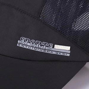 Detailed macro view of black mesh and canvas sport hat with silver metal plate