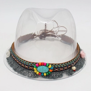 Detail of bohemian hat band with turquoise stone, colorful beads and grey tassels