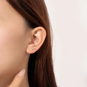 Minimalist S925 sterling silver gold studs with three vertical zircons on female ear