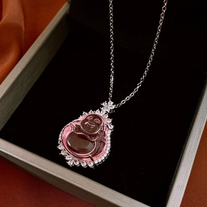 Macro detail of Maitreya Buddha pendant with pink zircon and silver rhinestone petals
