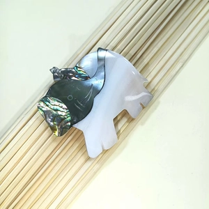 Detail of elephant pendant crafted with iridescent black and white mother of pearl shells