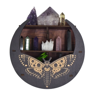 Detailed view of bohemian moon-shaped wooden crystal display shelf with carved moth motifs