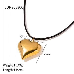 Macro shot of 3.52cm golden puffy heart pendant with long 144cm black cord necklace