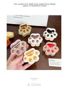 Detail view of colorful cat claw hair clips in multiple colors on a wooden surface