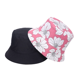 Détail d'un bob noir classique et d'un chapeau d'été rose à imprimé floral pour femme