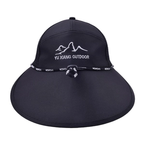 Detail of black outdoor sun hat featuring mesh vents and mountain logo embroidery