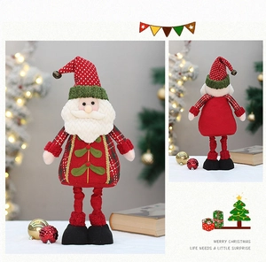 Detail of fabric Santa Claus figurine showing front and back views in festive home setting