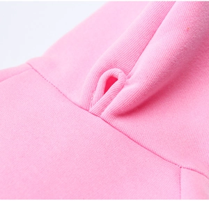 Close-up of pink dog hoodie showing drawstring hole and high-quality double stitching