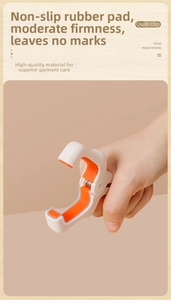 Close-up of windproof quilt clip with orange non-slip pads and strong metal spring