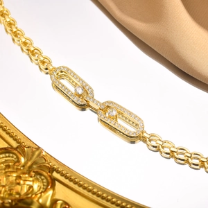 Macro shot of gold-plated copper chain bracelet with zircon pavé hollow links