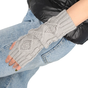 Detail of light gray cable-knit arm warmers showing soft wool texture and elastic ribbed cuffs