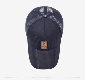 Detail of navy blue mesh baseball cap featuring a premium brown leather patch on the front