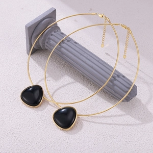 British vintage gold snake chain necklace featuring a black onyx geometric pendant