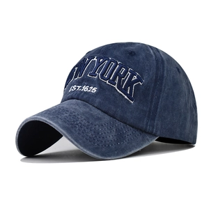 Close-up of New York 3D embroidery on washed cotton vintage style baseball cap