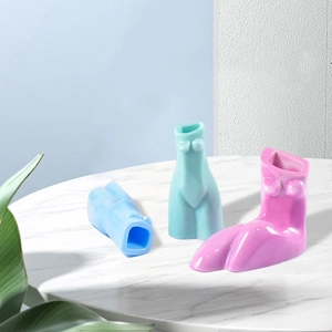 Three colorful female torso ceramic vases in blue, cyan, and pink for modern home decor