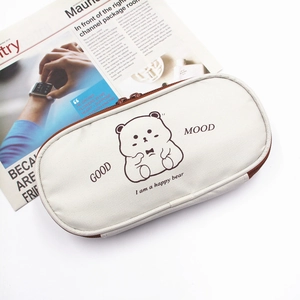 Detail of canvas pencil case showing the cute bear print and sturdy brown zipper texture