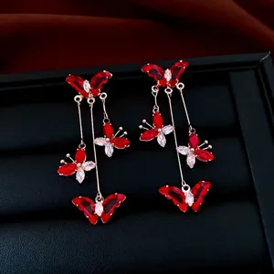 Elegant gold butterfly tassel earrings with red and white zircon stones for women