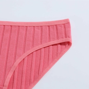 Detail of pink cotton ribbed underwear showing stitching and breathable fabric texture