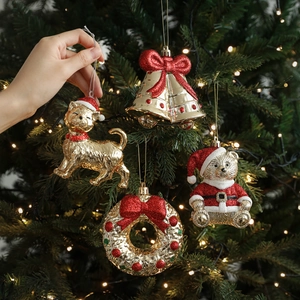 Christmas tree ornaments set featuring gold and red cats, bells and bears hanging on tree