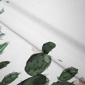Detail showing the thick textured fabric and green cactus print on the white wall tapestry