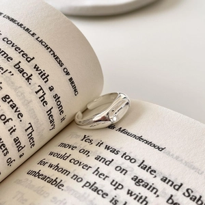 Minimalist 925 sterling silver open ring shown on an open book page for a stylish look