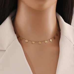 Close-up of golden stainless steel butterfly necklace with tree of life charms on model