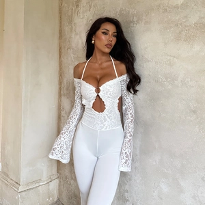 Macro shot of white lace texture and hollow waist design on a slim fit jumpsuit