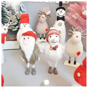 Detailed close-up of handmade wool felt Santa and reindeer Christmas ornaments