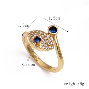 Close-up of gold evil eye ring with blue and white cubic zirconia and size details
