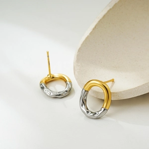 Two-tone 18K gold and silver oval stud earrings with unique ripple texture detail