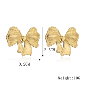 Detailed view of 18K gold bow earrings with 2.5cm by 3.2cm size and 10g weight