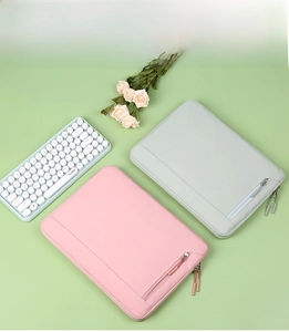 Detail of pink and mint green laptop sleeves with convenient front zipper pockets
