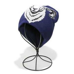Detailed close-up of dark blue knit beanie featuring a jacquard animal tiger head pattern