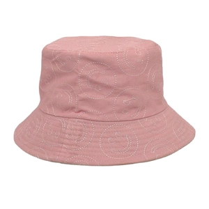 Close-up of pink cotton fisherman hat featuring white embroidered smiley face patterns
