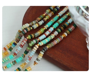 Macro shot of colorful beaded necklace with natural stones and golden spacer beads