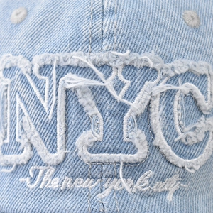 Distressed light blue NYC denim baseball cap with vintage embroidery details