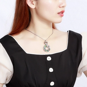 Vintage stainless steel necklace featuring circular pendant with colorful crystal glass