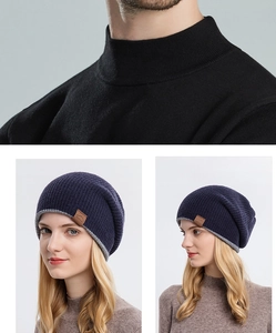 Close-up of knit beanie fabric texture and leather logo detail on folded cuff