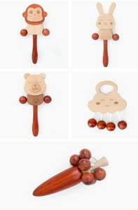 Detail of wooden Montessori baby rattles in animal shapes like monkey and rabbit