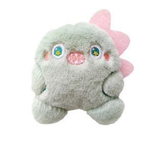 Cute green plush monster doll with pink dorsal fins and detailed facial embroidery